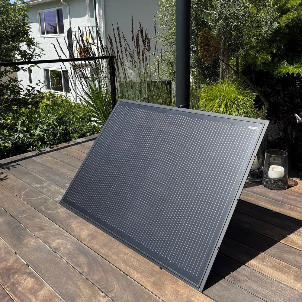 One Bright Saver solar panel resting on a wooden deck.